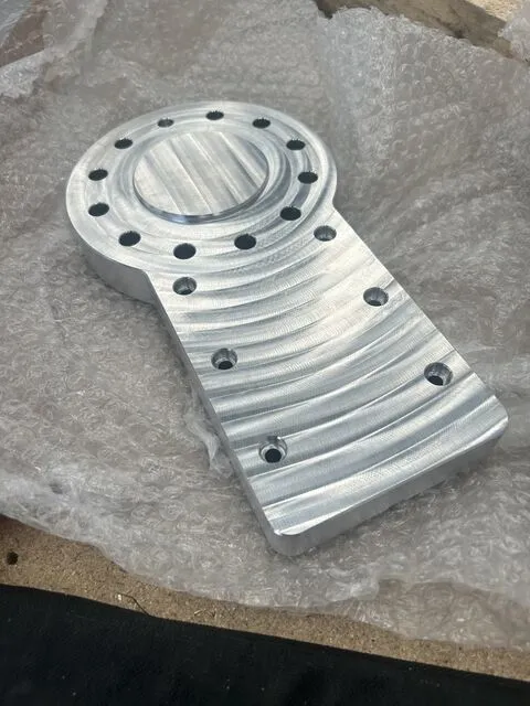 Second machined view of the aluminium spindle plate showing the boss and fixing holes.